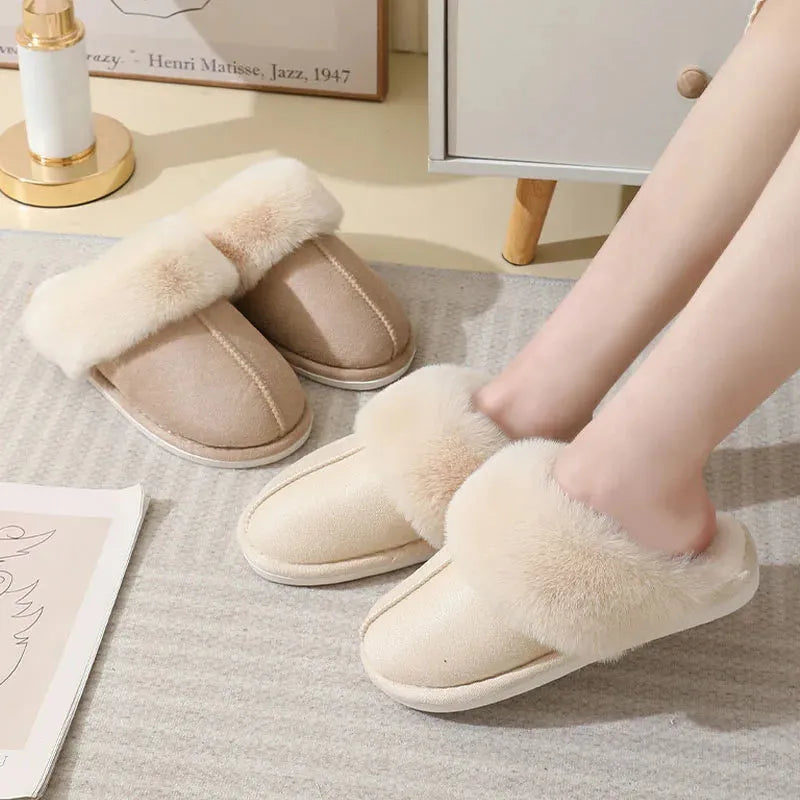 Brown plush indoor slippers with round toe, flat heel, and stitched detail on a PVC sole.