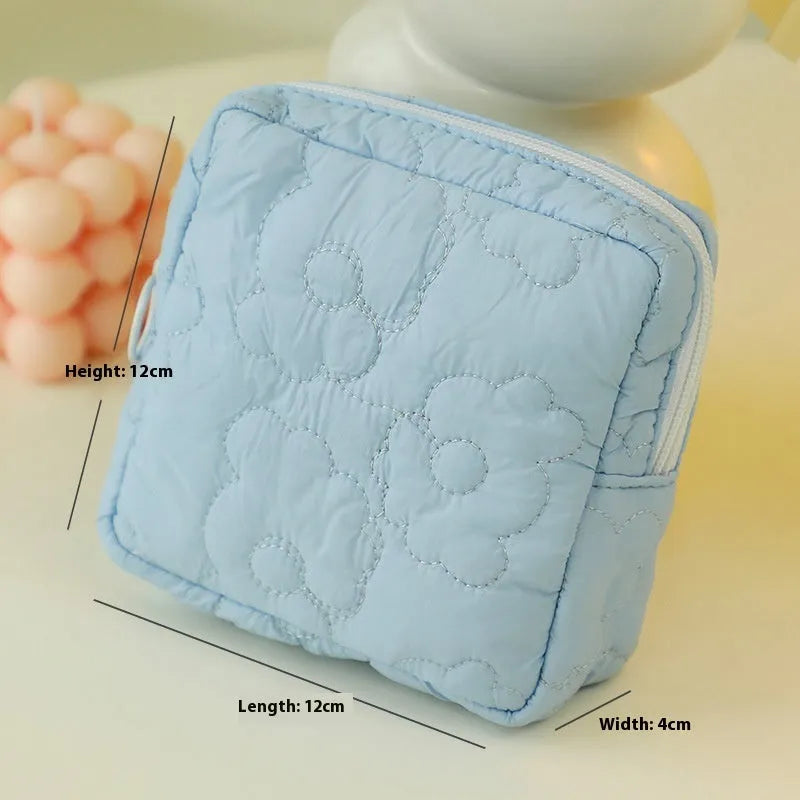 Quilted silk cosmetic bag in multiple colours including pink, blue, green, white, and yellow
