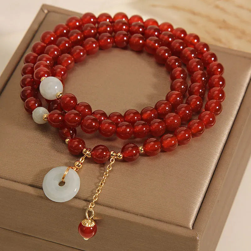 Red agate multi-layer bracelet with adjustable closure showing natural stone texture