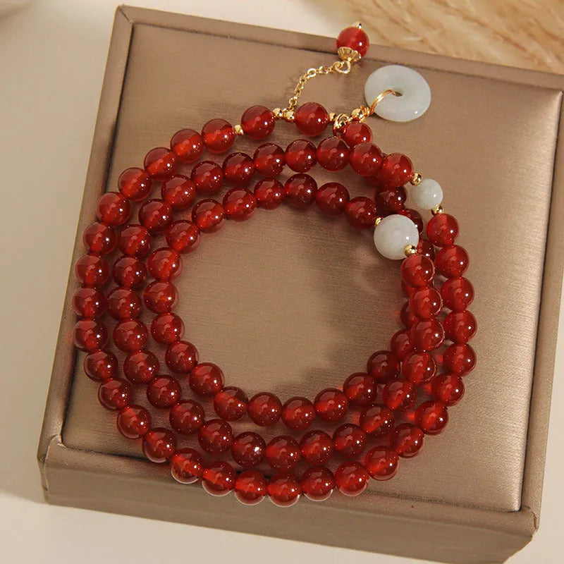 Red agate multi-layer bracelet with adjustable closure showing natural stone texture