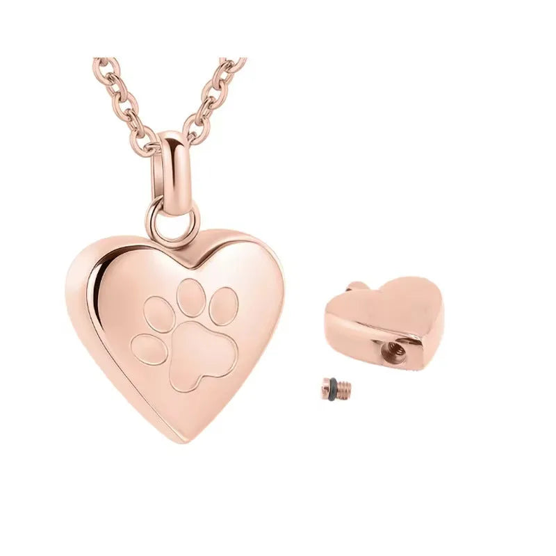 Silver heart pendant necklace with paw print design that opens as a casket.
