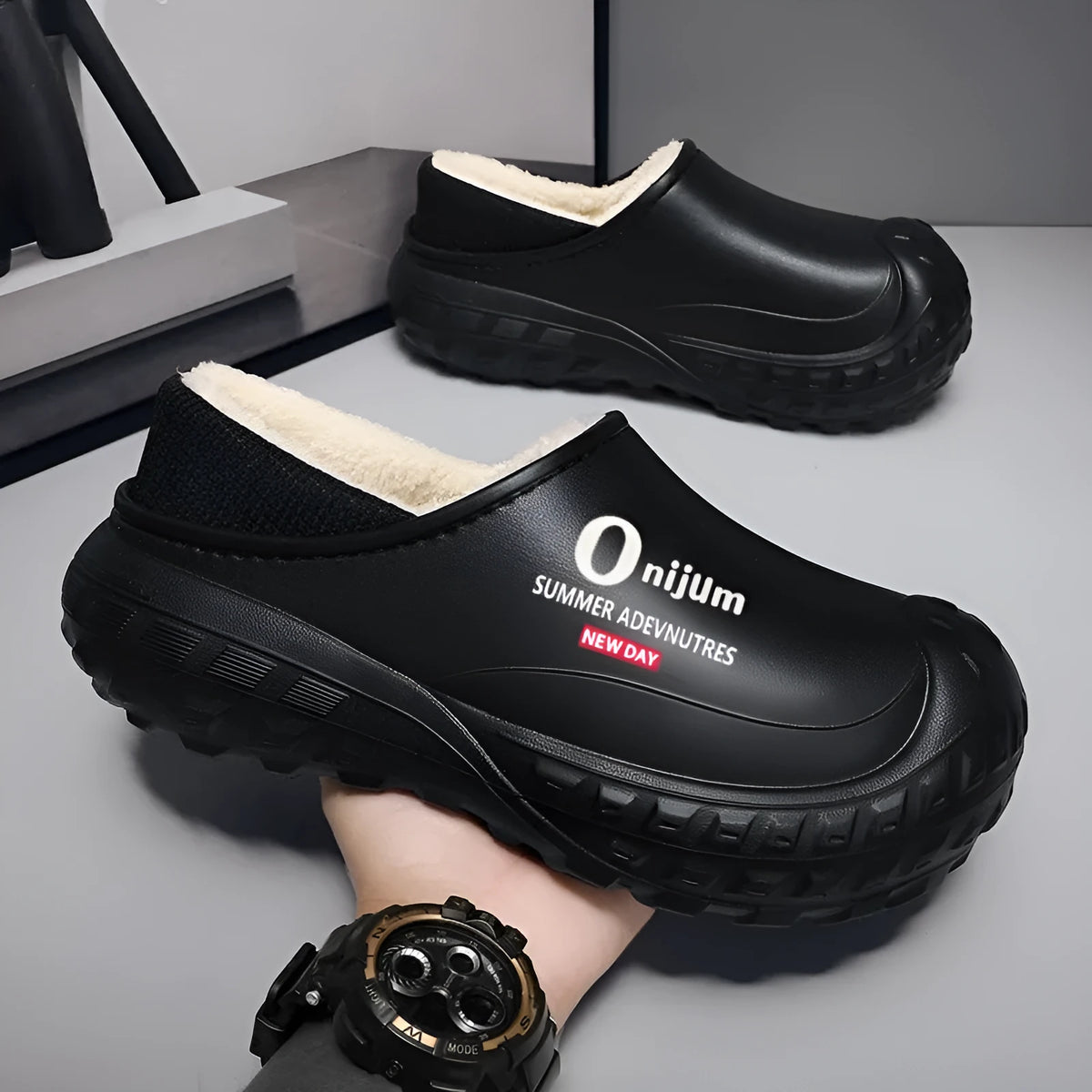 Winter fleece-lined men's home cotton shoes with anti-slip sole, printed letter pattern in black, on a floor