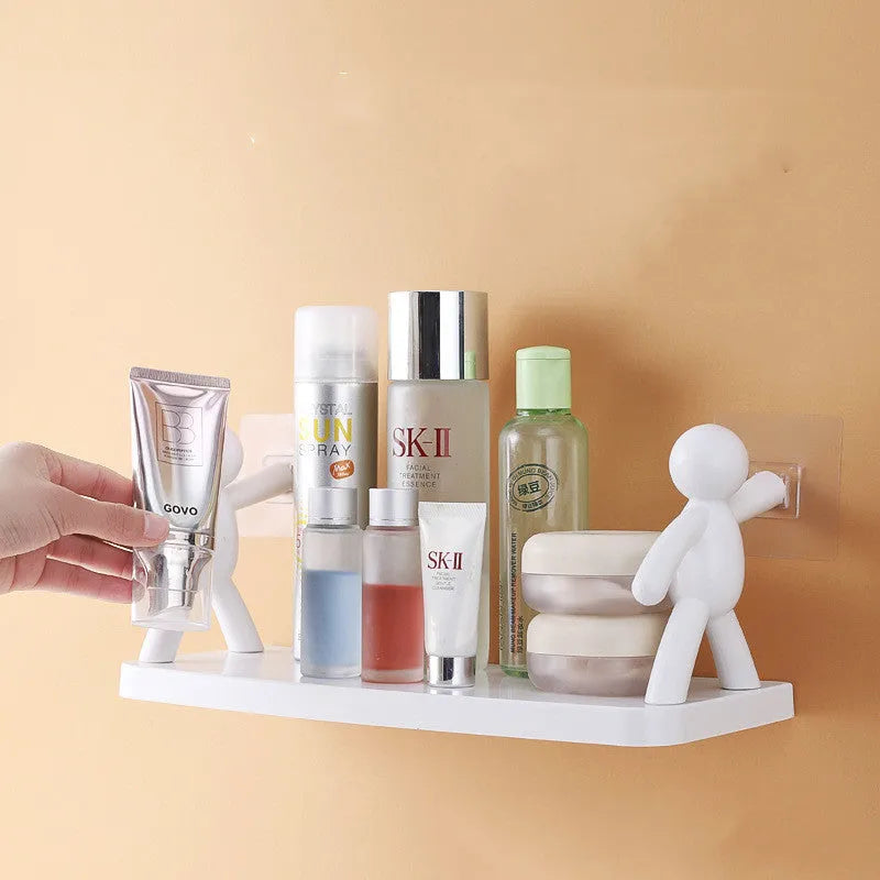 White plastic wall-mounted storage shelf in little man doll design on a bathroom wall