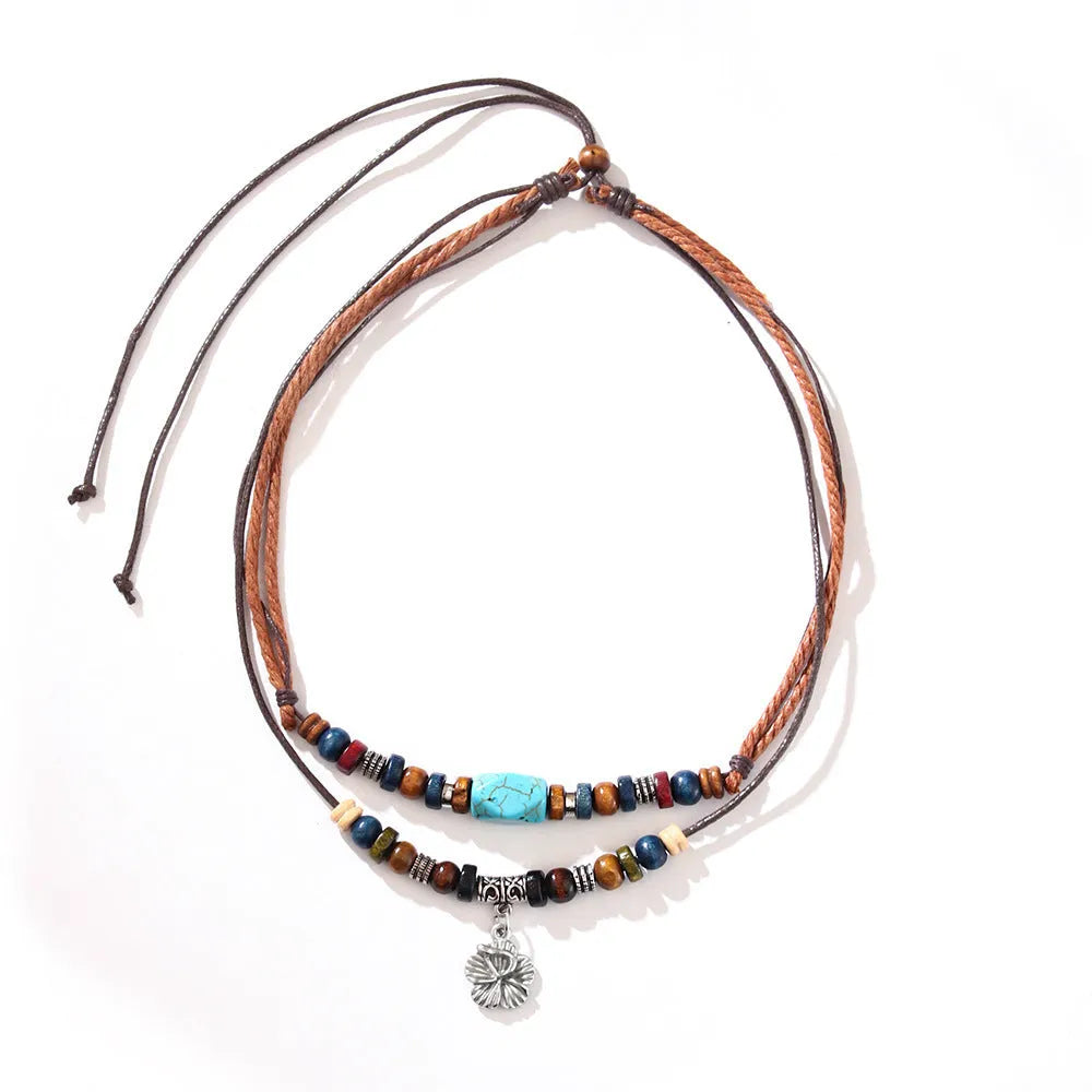 Wooden bead necklace with alloy floral pendant and turquoise wax rope in retro design