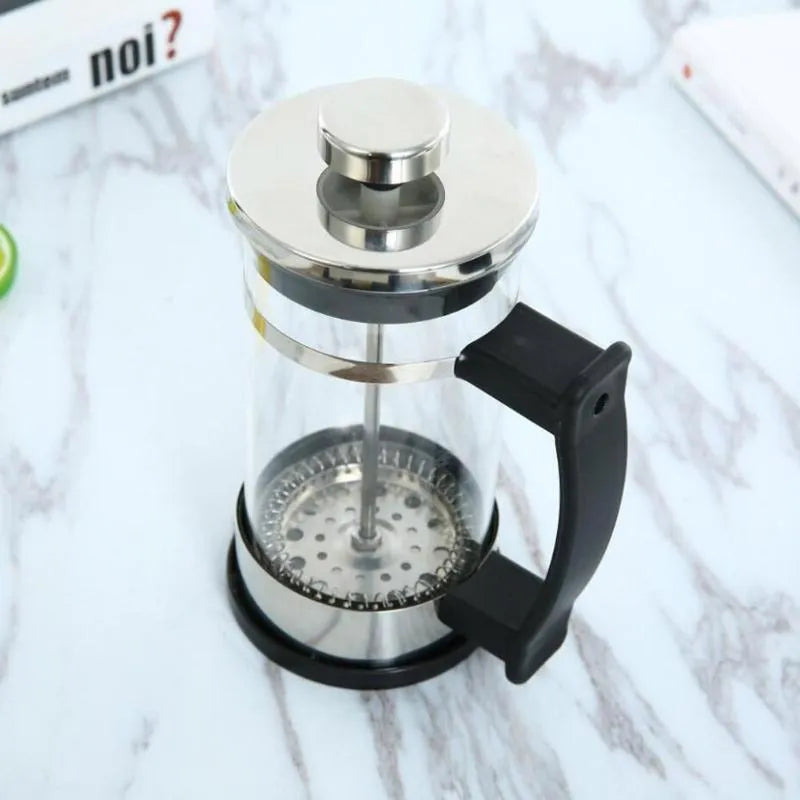 Manual pour-over coffee maker with glass carafe and stainless steel filter, 350ml capacity.