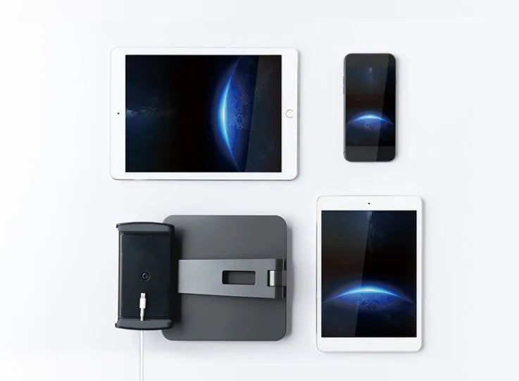 Silver foldable aluminium phone and tablet stand on a desk, holding a tablet at an angle.