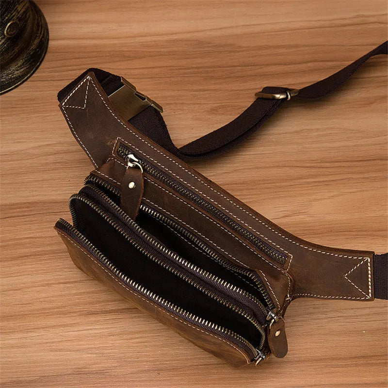 Brown genuine cowhide men's sports waist bag with pull closure showing internal mobile phone pocket