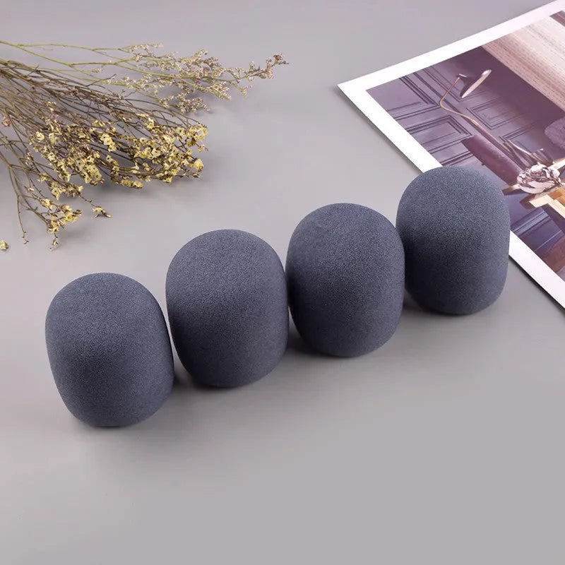 Four multicoloured foam microphone windshields for ball-shaped handheld stage microphones