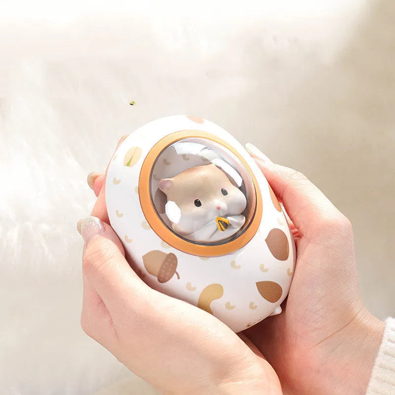 White Hamster space capsule-shaped hand warmer and power bank with USB port