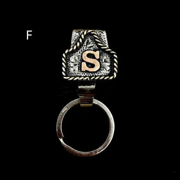 Handmade metal cow tag style key holder shown in one of its 26 colour options, attached to a keyring.