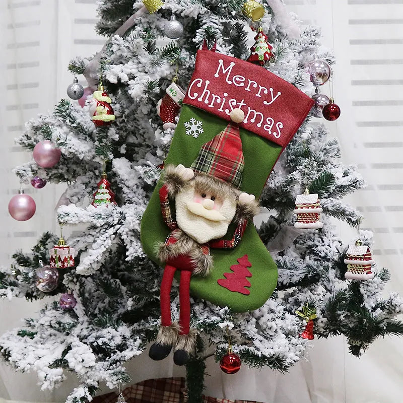 Three large Christmas stockings with Santa, Snowman and Reindeer 3D designs hanging for holiday decoration