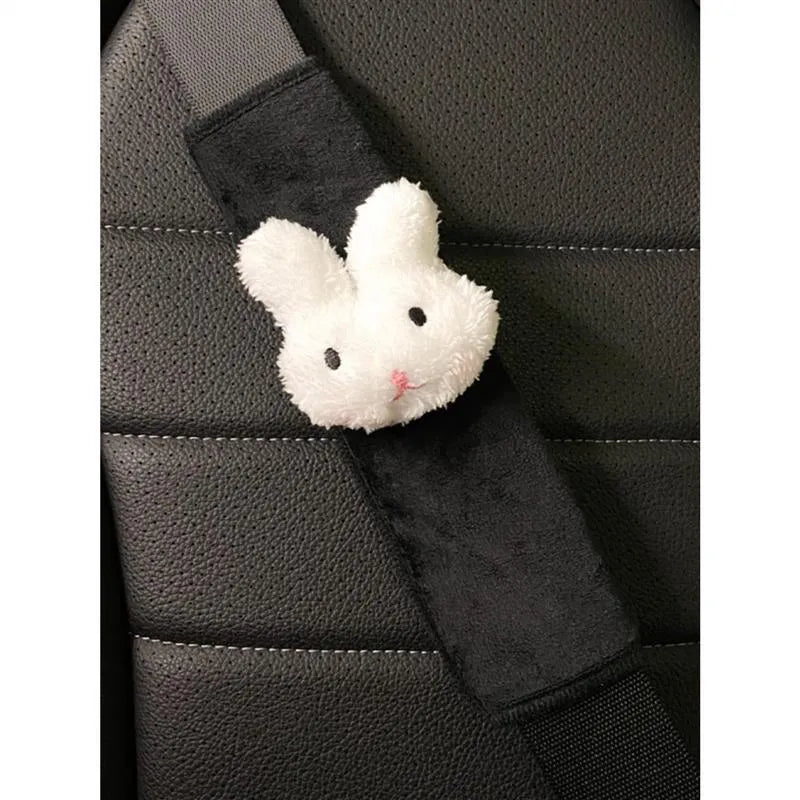 Creative cartoon plush universal automobile seat belt shoulder protector in big-eyed panda design on a grey car seat belt