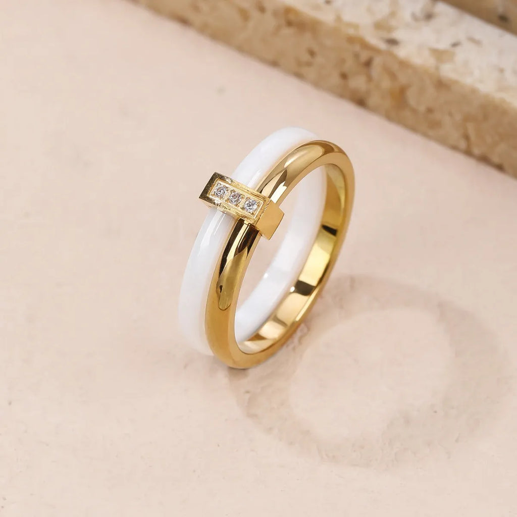 Women's titanium steel heart-shaped double ring with glossy stitching and zirconium accents in gold black.