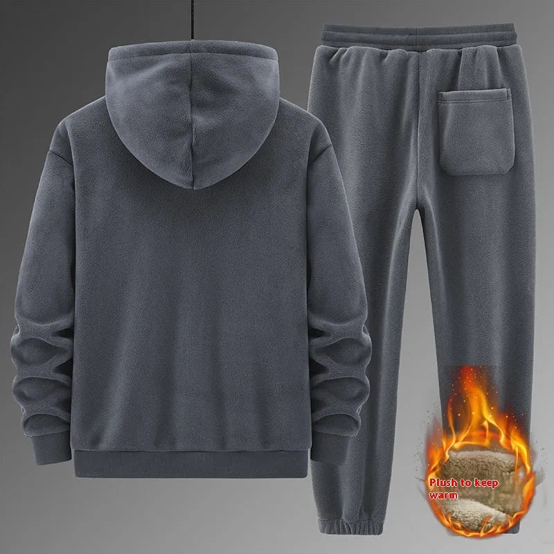 Grey cashmere hooded sportswear suit with long sleeves and matching trousers on a hanger