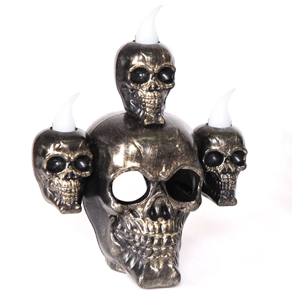 Halloween skull ornament with LED light, gold and silver, plastic, 14x12x9cm, on dark background