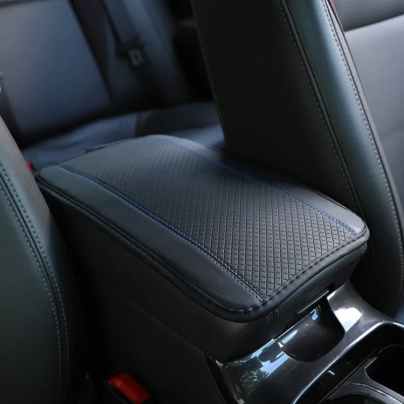 Black embossed PU leather car armrest box cushion mat measuring 32 by 19 centimetres.