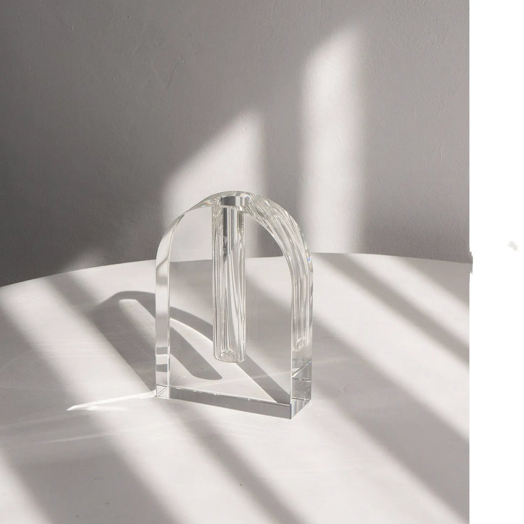 Transparent crystal vase with solidified bubble patterns on a simple modern background