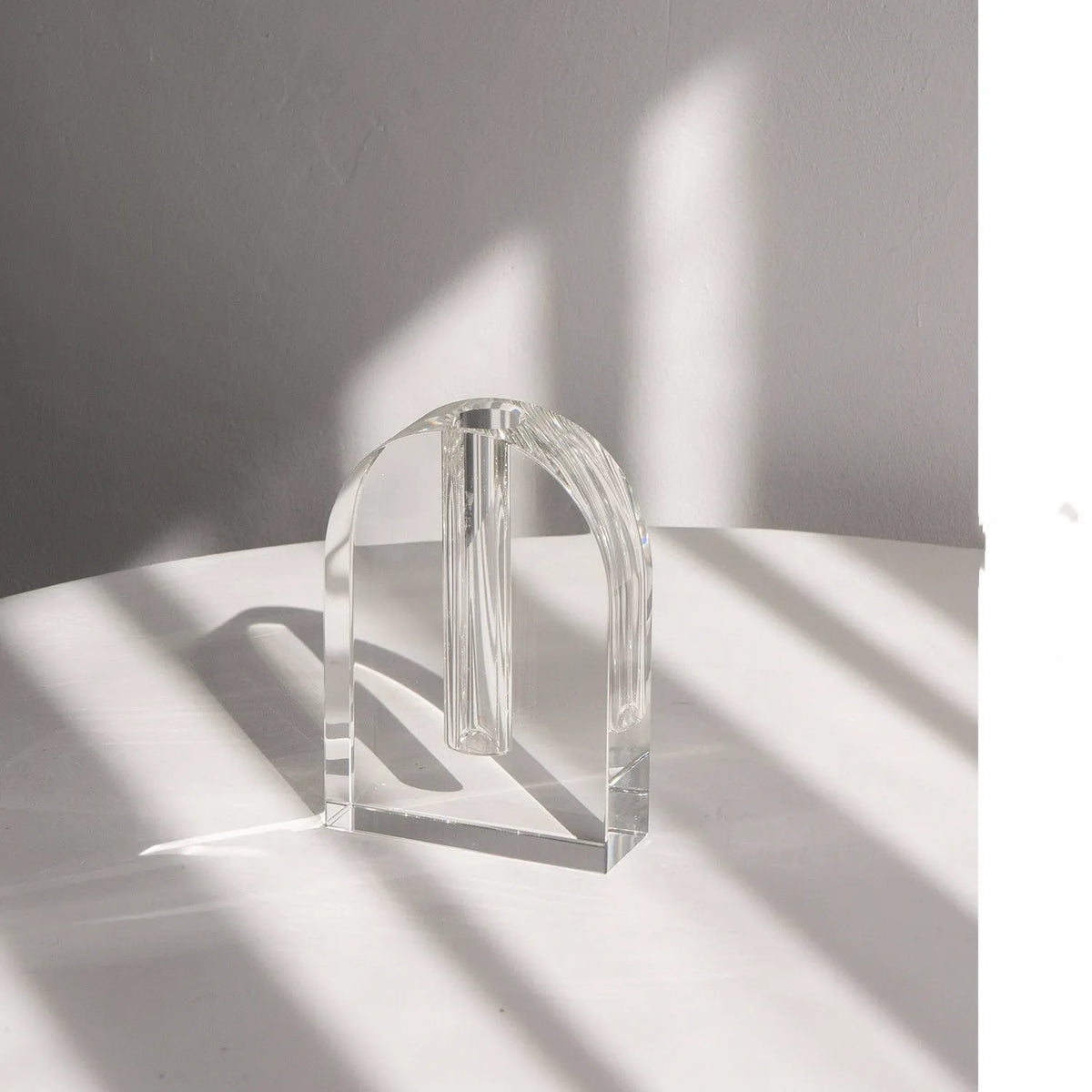 Transparent crystal vase with solidified bubble patterns on a simple modern background