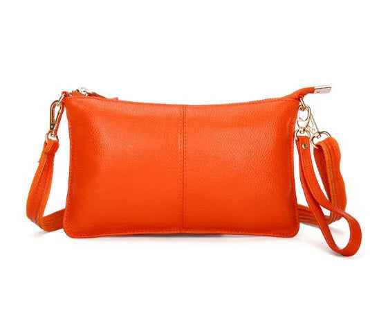 Lady's cowhide leather slant bag in apricot colour with hand strap and shoulder strap showing zipper compartments