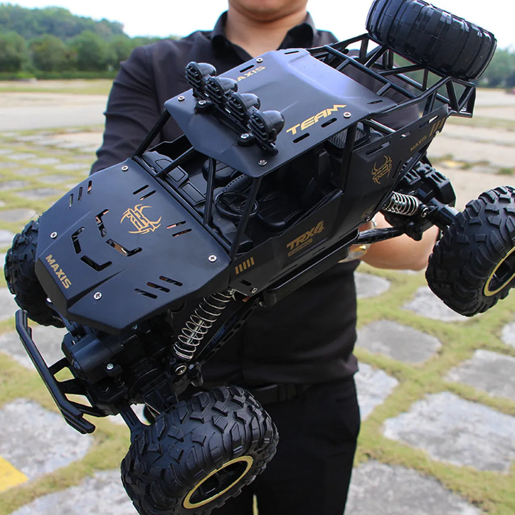 Large black 4WD remote control climbing car and smaller silver high-speed model with 2.4G remote.