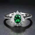 Blue moissanite stone set in a copper flower-shaped ring available in green, red, or blue.