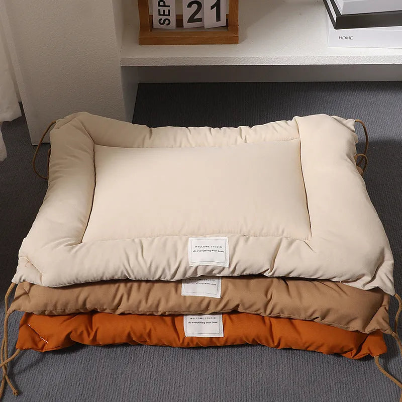 Beige pet cage cushion secured inside a metal dog crate, showing tie straps.