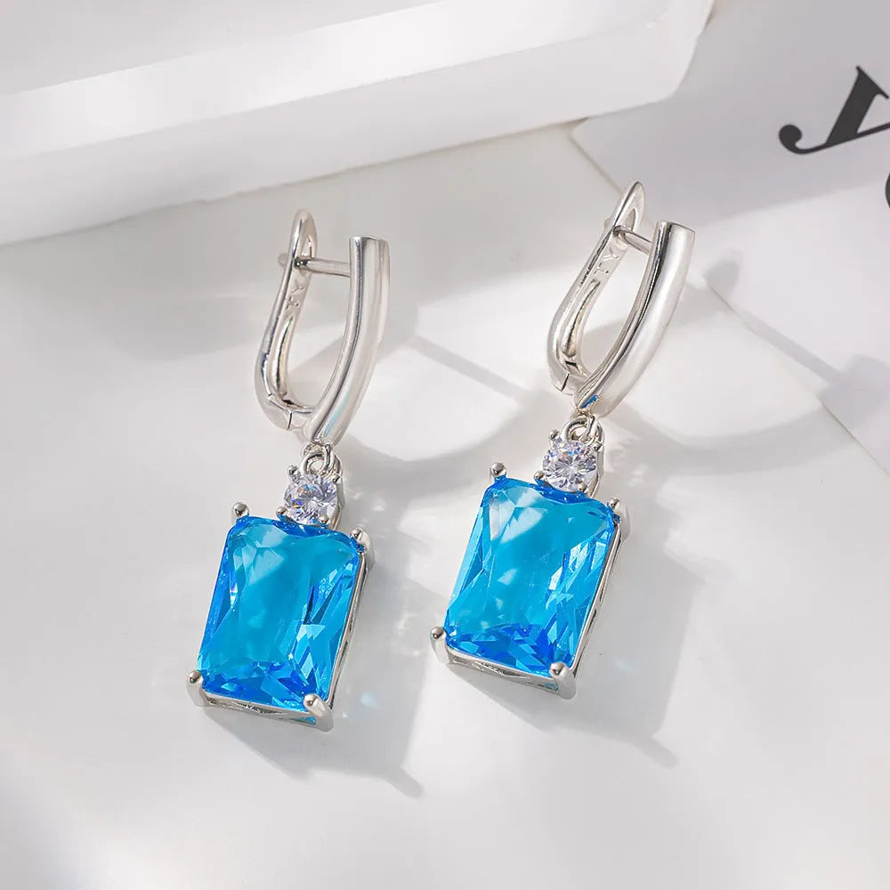 Square copper earrings with electroplated gold or silver finish and quadrilateral geometry