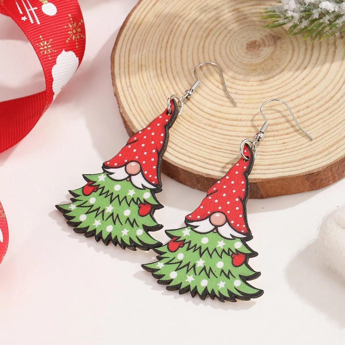 Wooden Christmas earrings with printed tree and snowman designs on geometric shapes