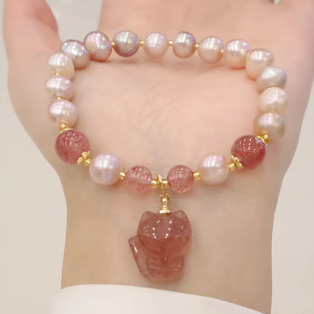 Light pink freshwater pearl bracelet for women with a dangling silver fox charm.