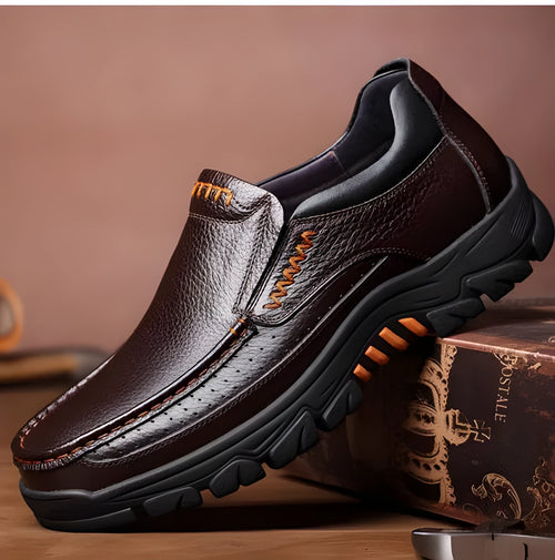 Men's black and brown business casual slip-on shoes made from cowhide leather with rubber soles.