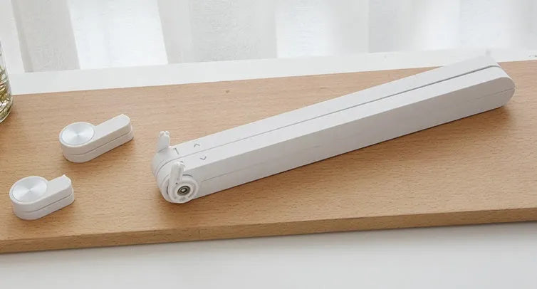 White foldable laptop stand on a desk, showing its elevated, angled position for ergonomic use.