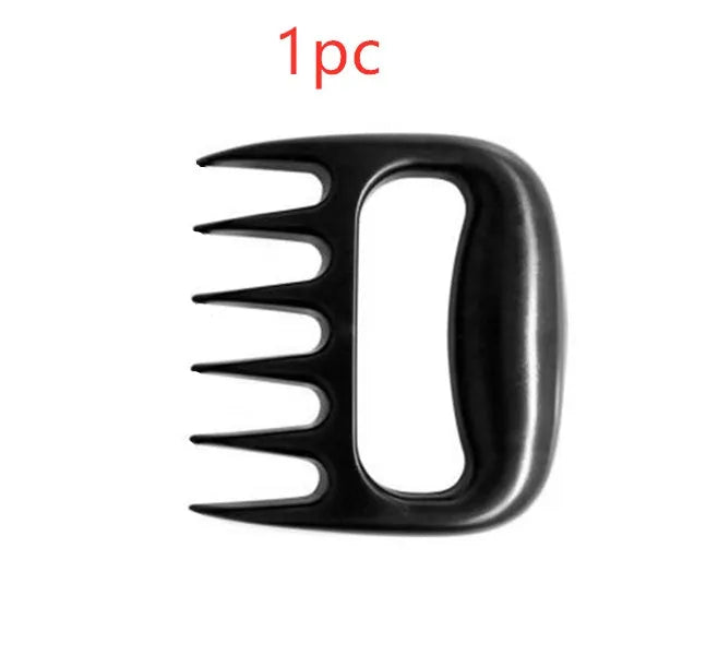 Black bear claw meat shredder utensil for pulling pork and chicken on a kitchen surface.