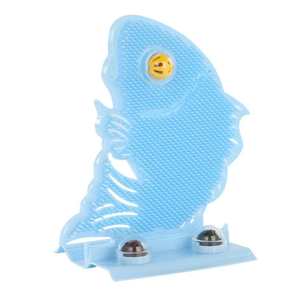 Blue plastic fish-shaped cat wall scratcher with brush, two green catnip balls, a bell, and a mounting base.