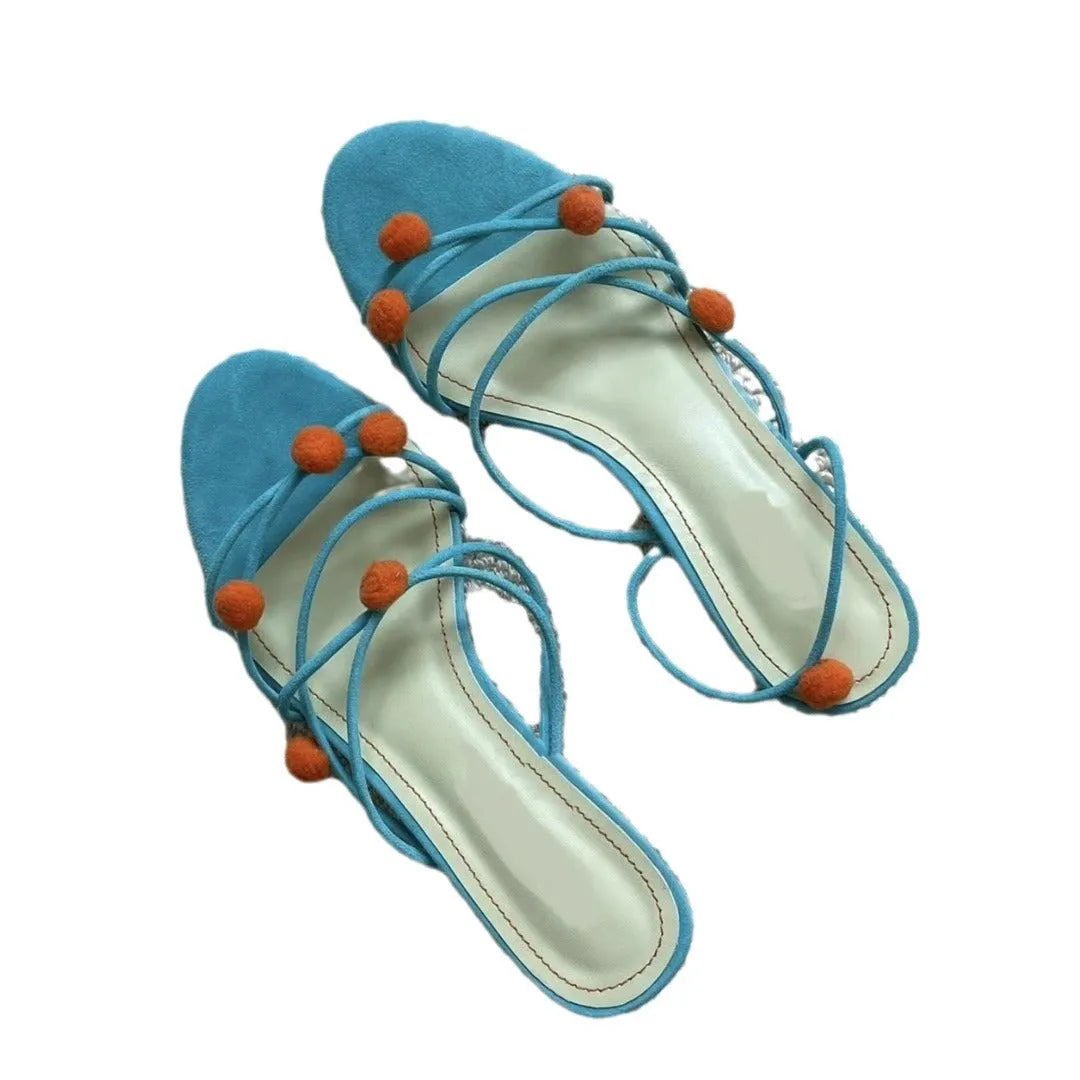 Cyan women's high-heeled sandals with lace-up ball detail and thin straps, open toe, on a rubber sole.