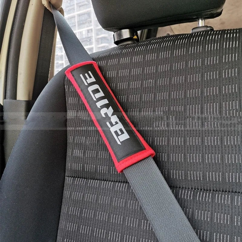 Car safety belt shoulder pad set in black showing cotton construction and embroidery detail