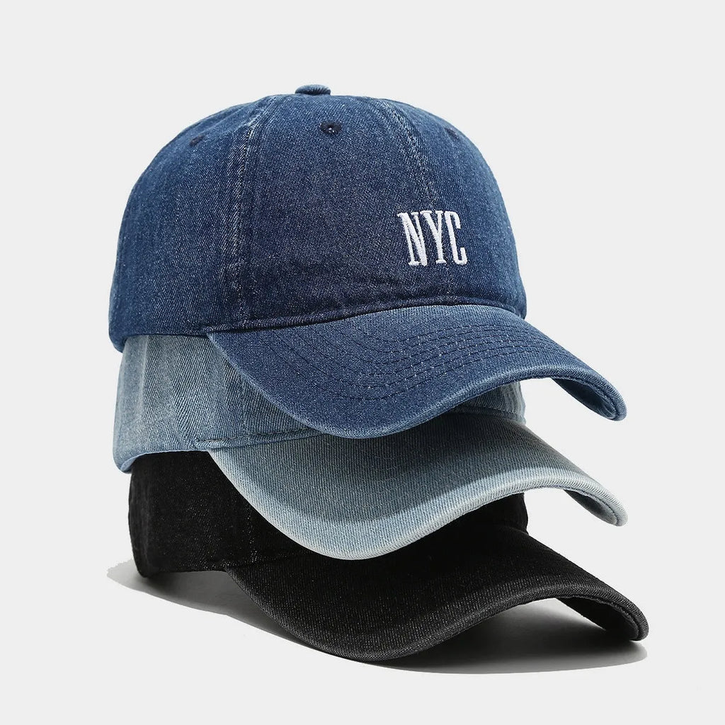 Retro denim peaked cap with embroidered letters on the front, shown in an adjustable size.