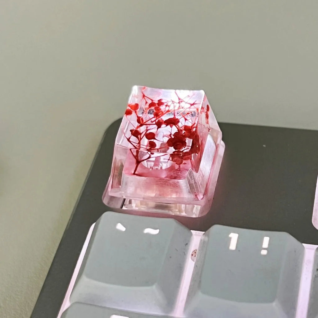 Transparent resin mechanical keyboard keycap with starry sky pattern in red, pink, green, and violet colour options