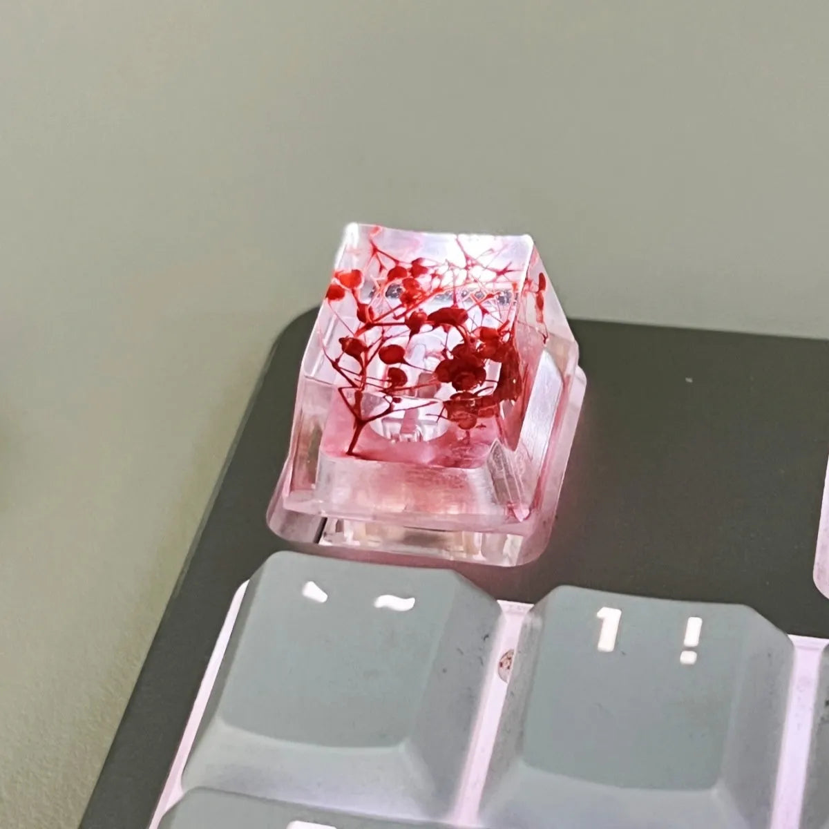 Transparent resin mechanical keyboard keycap with starry sky pattern in red, pink, green, and violet colour options