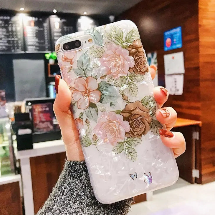 Dream Shell soft TPU iPhone case with rose flower pattern on back, shown in brown colour.