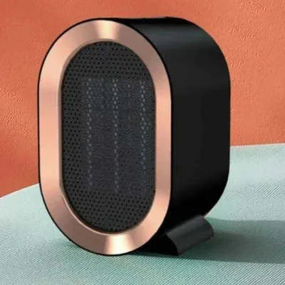 Desktop electric fan heater with black casing and UK plug, showing control knob and air vents