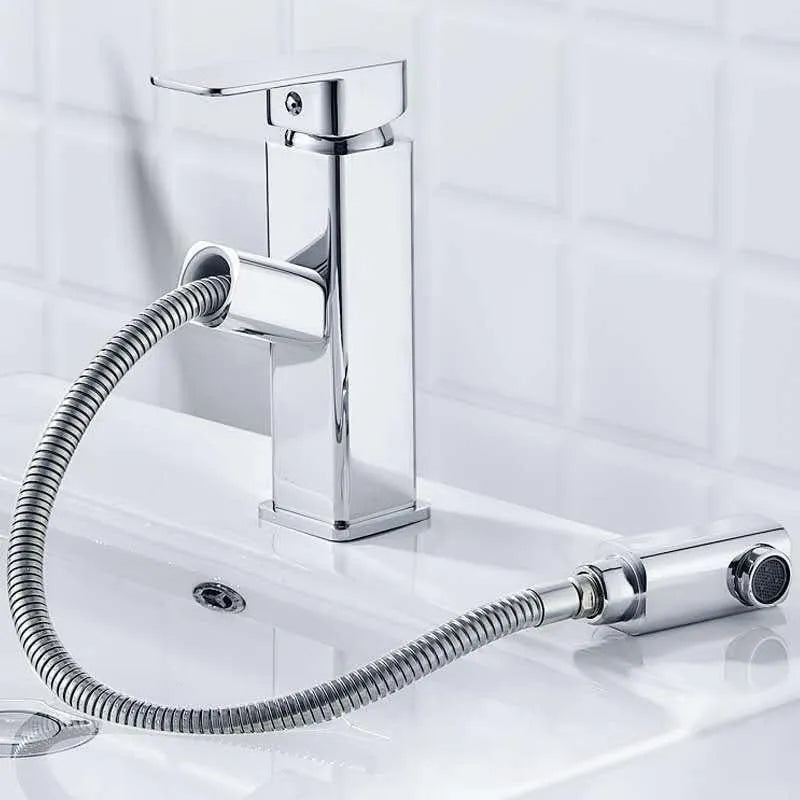 Square handle brushed gold pull faucet with brass construction on a sink.