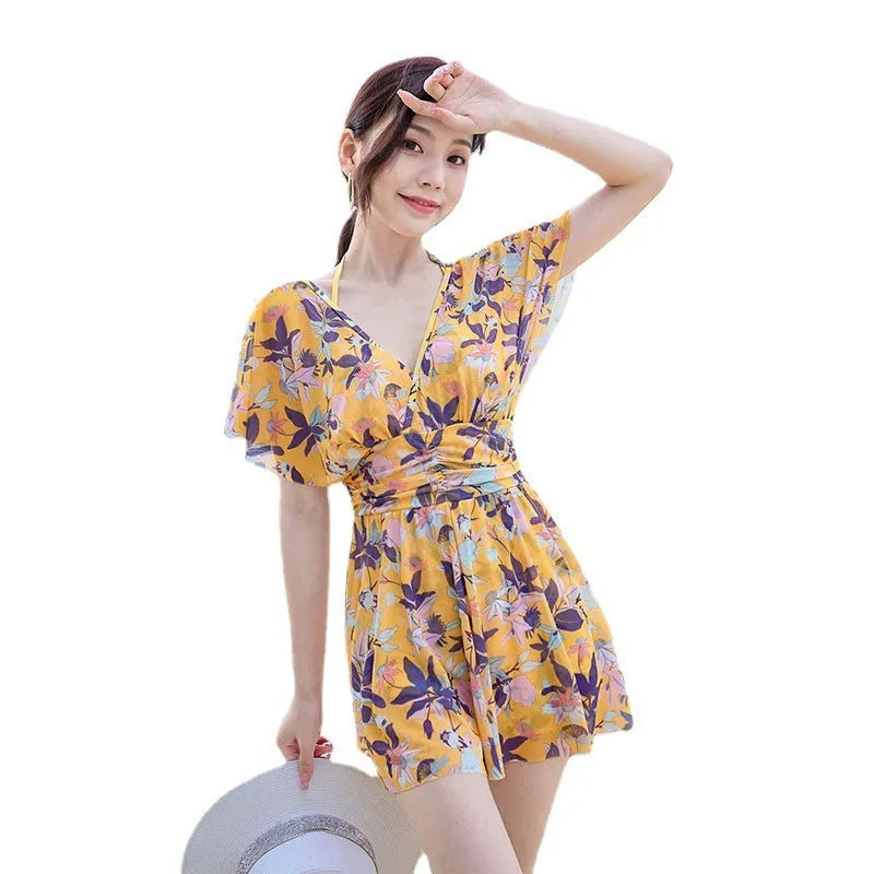 Yellow floral print women's one-piece swimsuit on hanger showing front design