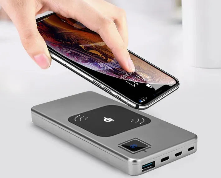 Silver alloy portable power bank with LCD display showing battery percentage.