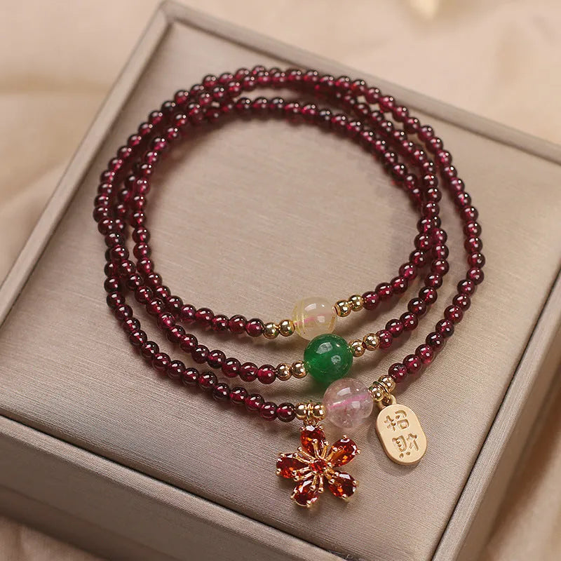 Women's crystal pomegranate bracelet with red cherry blossom beads and sequin detailing