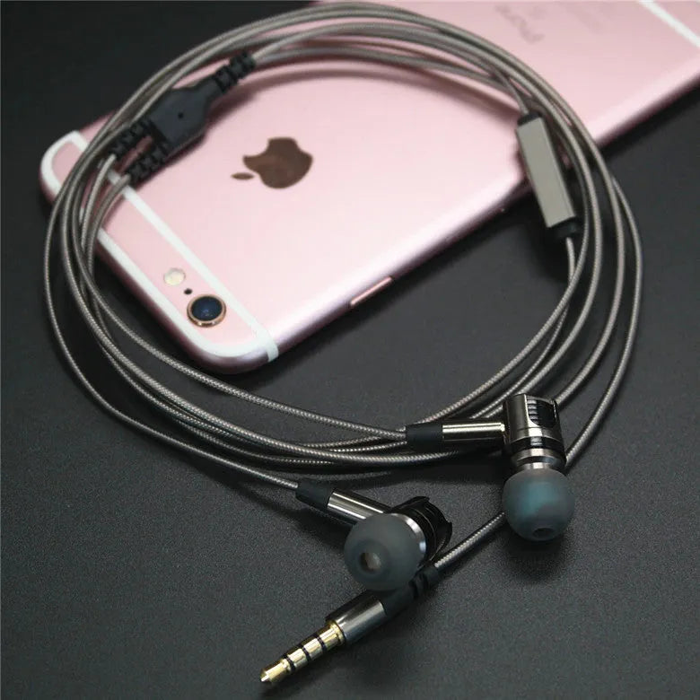 Titanium grey metal in-ear earphones with a detachable cable on a grey background.