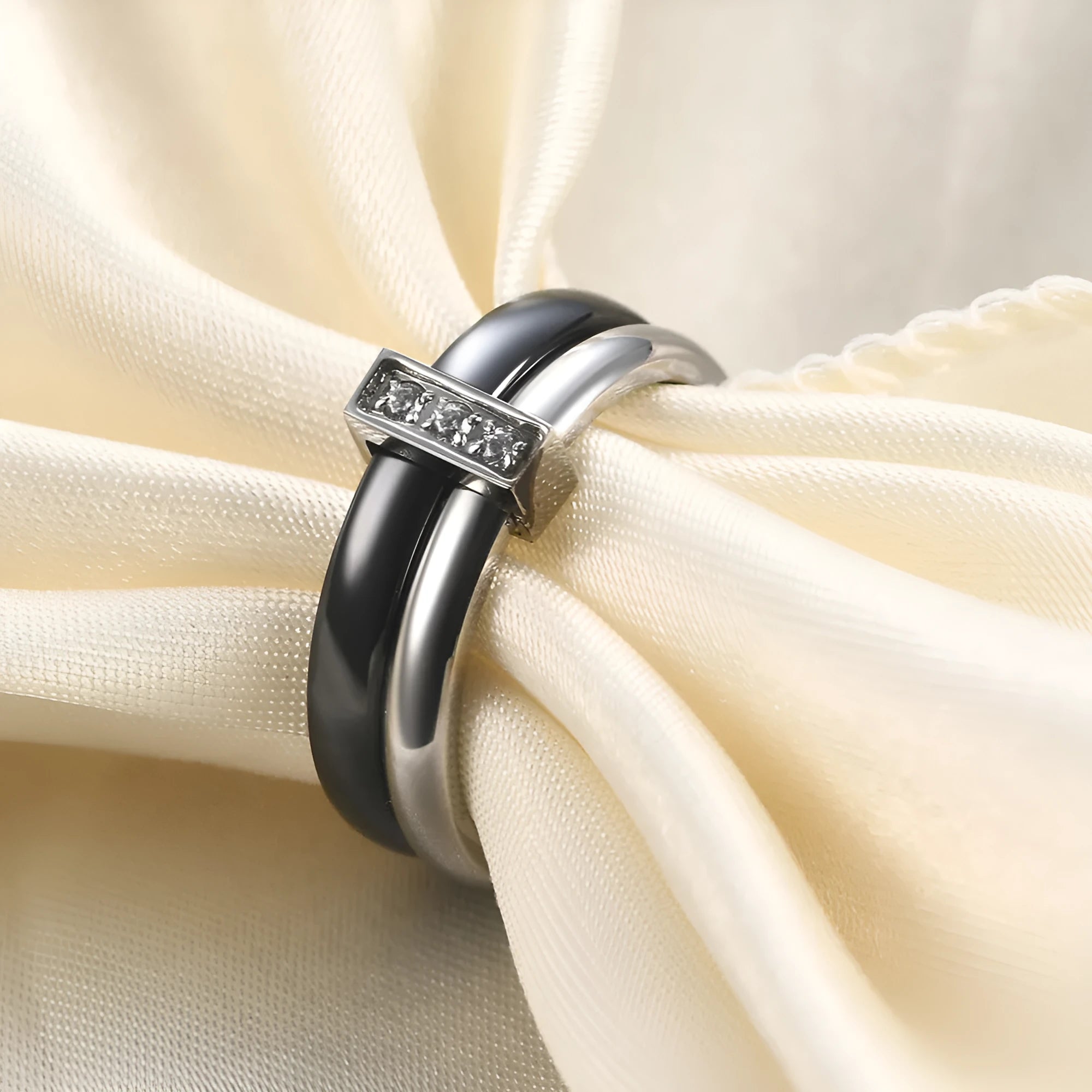 Glossy black ceramic women's ring with silver stitch-inlaid zirconium detail on a geometric band.