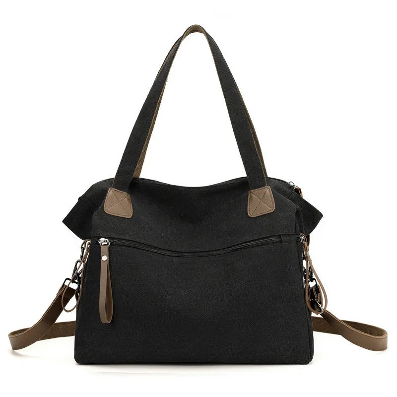 Large khaki retro canvas shoulder bag for women showing external sandwich pocket and internal organiser compartments.