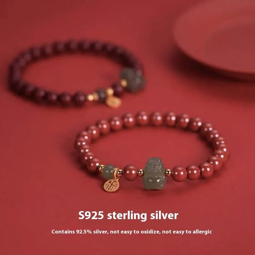 Handmade Hetian jade bracelet with cinnabar inlay showing 8mm beads and animal zodiac modelling