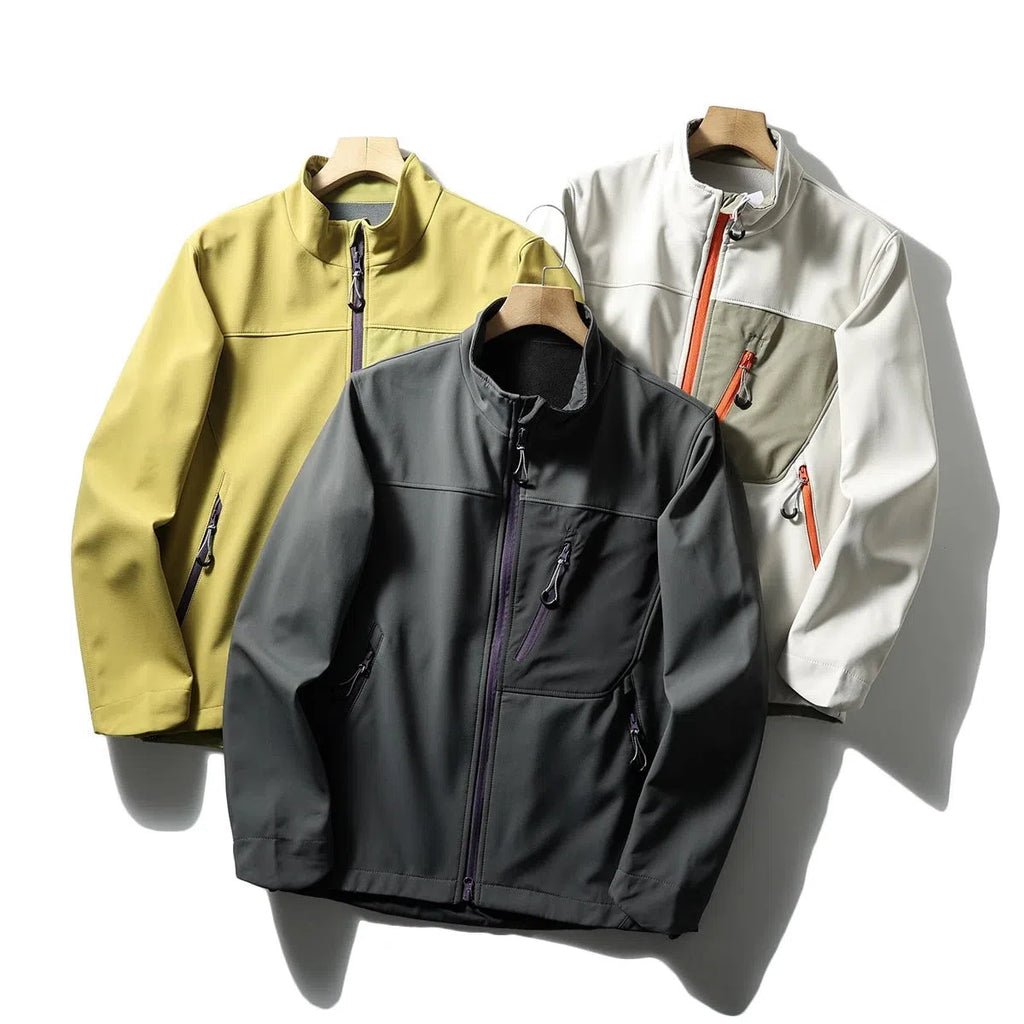 Men's retro patchwork contrast colour stand-up collar coat in Misty White, side view showing zipped pockets
