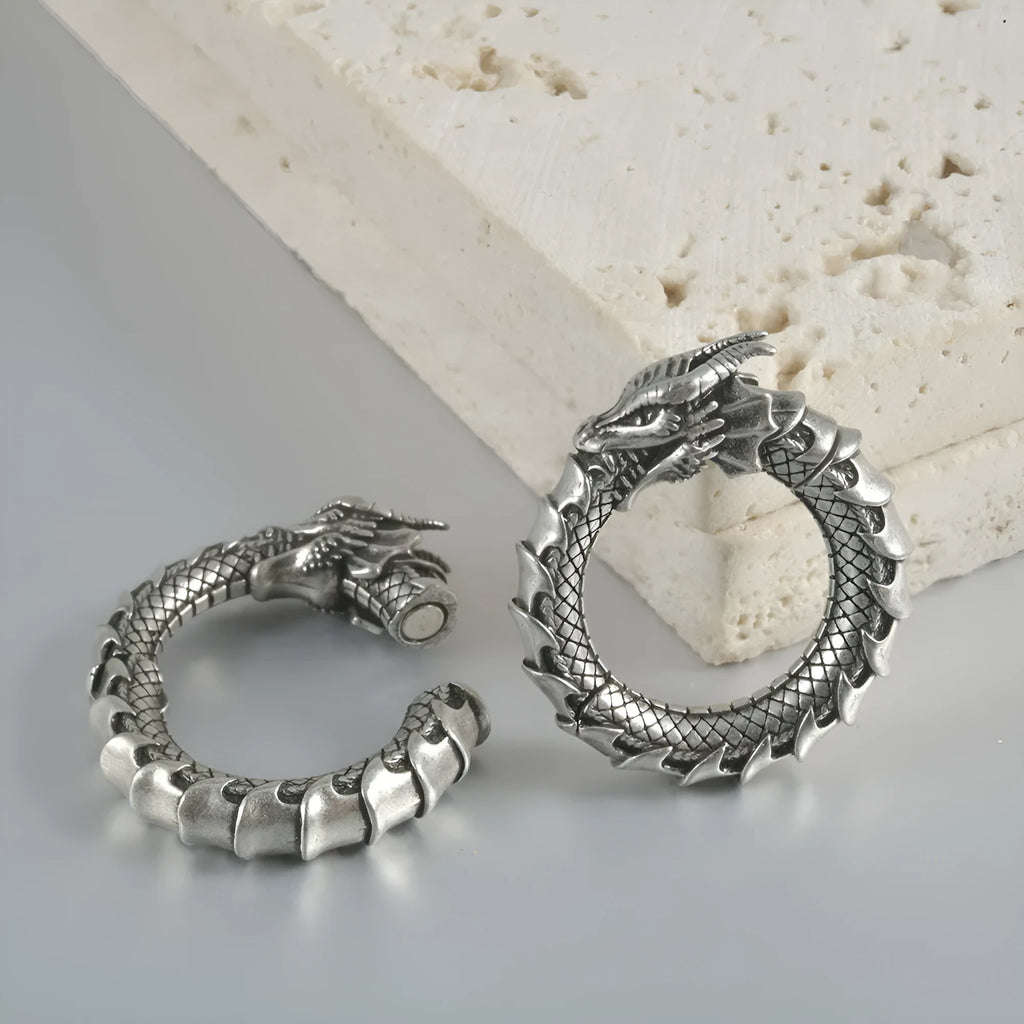 Large hollow out stainless steel earrings with an antique silver dragon design.